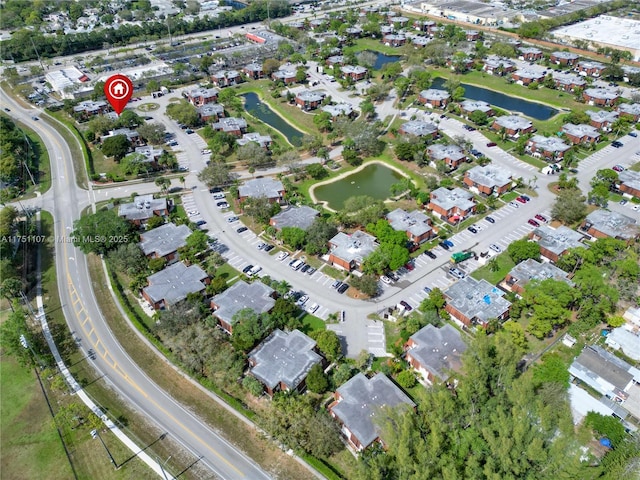 birds eye view of property with a water view and a residential view