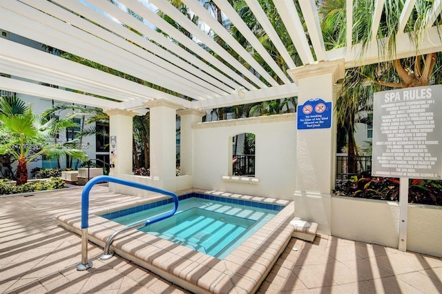 view of pool featuring a hot tub and a pergola