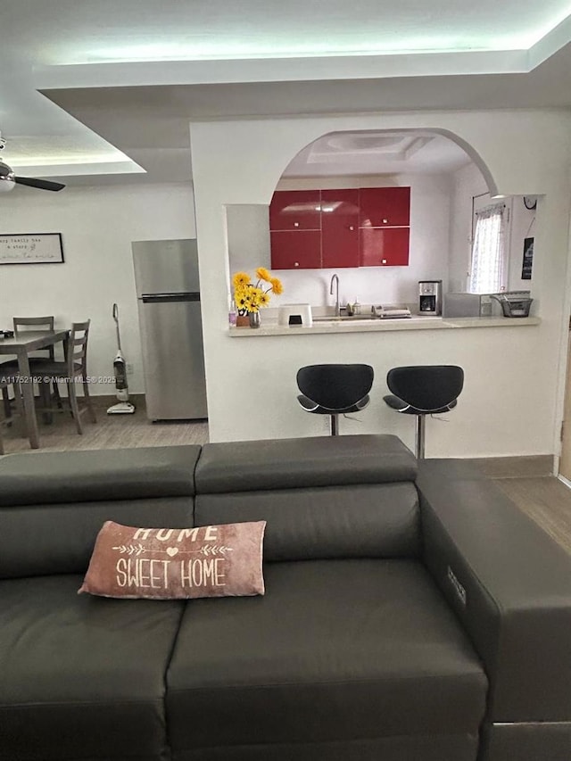 16900 NE 14th Ave Unit 209, Miami, FL 33162 - living area featuring a ceiling fan, baseboards, wood finished floors, and arched walkways