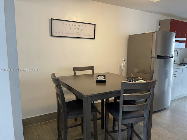 dining room featuring baseboards and wood finished floors