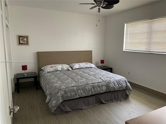 bedroom featuring ceiling fan and dark wood-style flooring