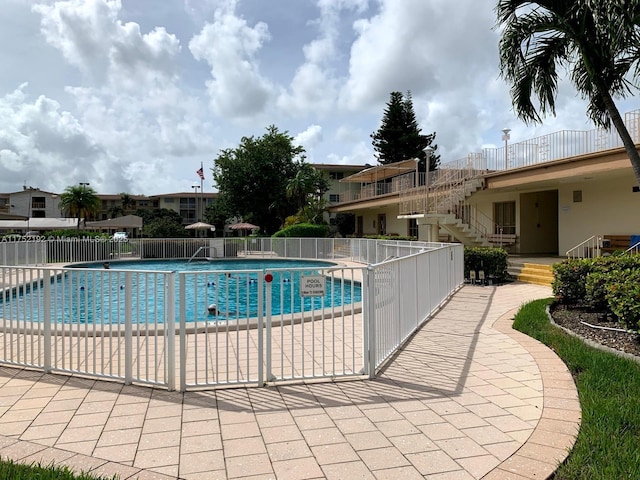 16900 NE 14th Ave Unit 209, Miami, FL 33162 - community pool featuring stairs and a patio
