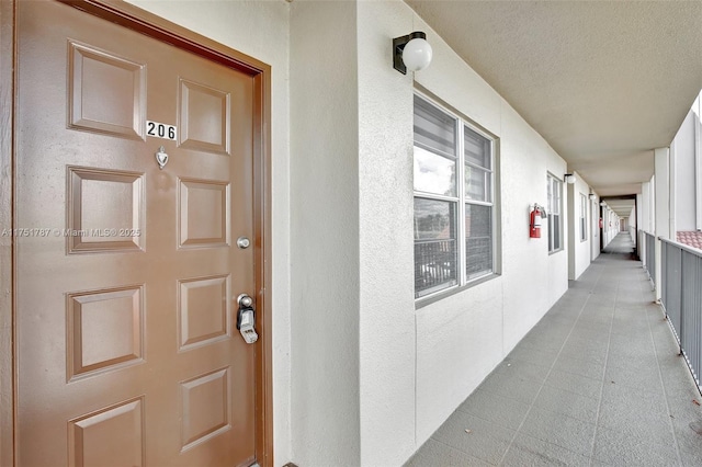 entrance to property with stucco siding