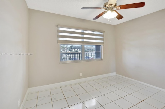 empty room featuring a ceiling fan and baseboards