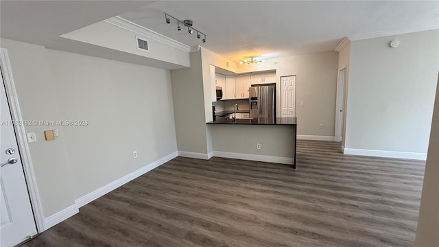 kitchen featuring dark wood finished floors, dark countertops, visible vents, white cabinets, and stainless steel fridge with ice dispenser