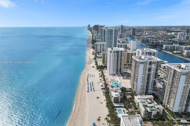 birds eye view of property featuring a water view, a view of the beach, and a city view