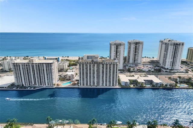 birds eye view of property with a water view and a view of city