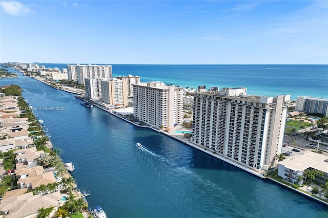 birds eye view of property with a water view and a city view