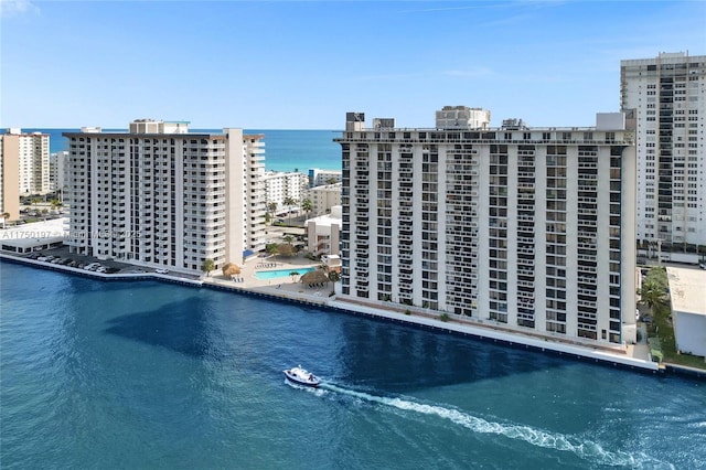 birds eye view of property with a water view and a view of city