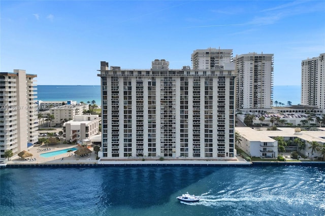 birds eye view of property featuring a water view and a city view