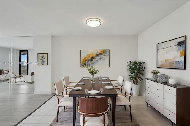 dining space with light tile patterned flooring and baseboards