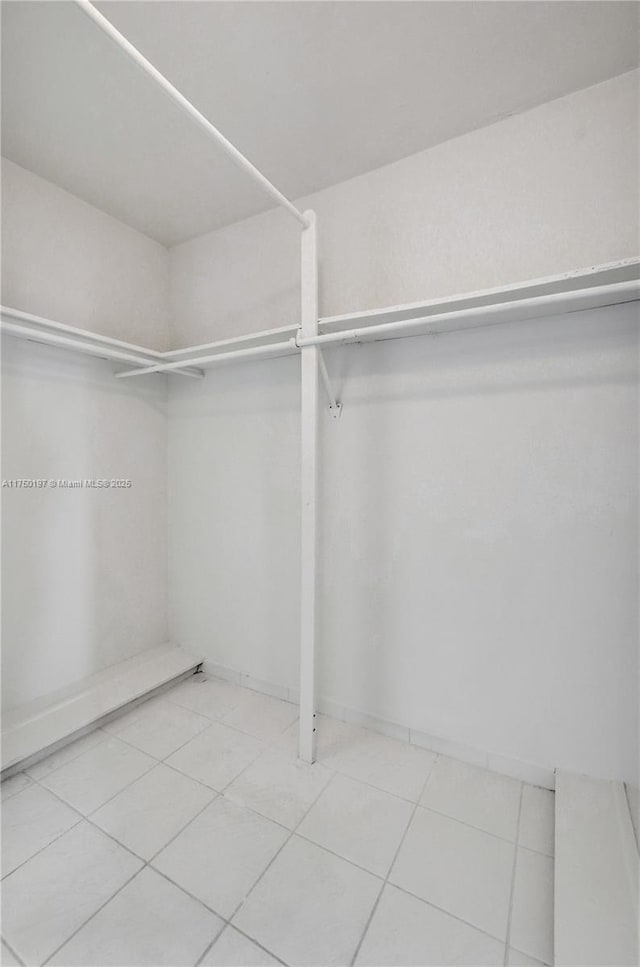 spacious closet featuring tile patterned flooring