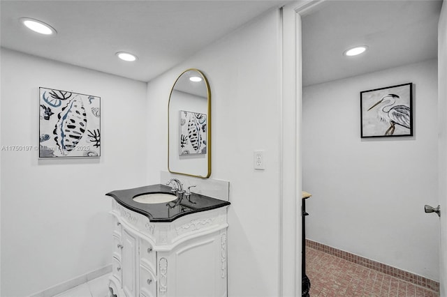 bathroom featuring recessed lighting, tile patterned flooring, vanity, and baseboards