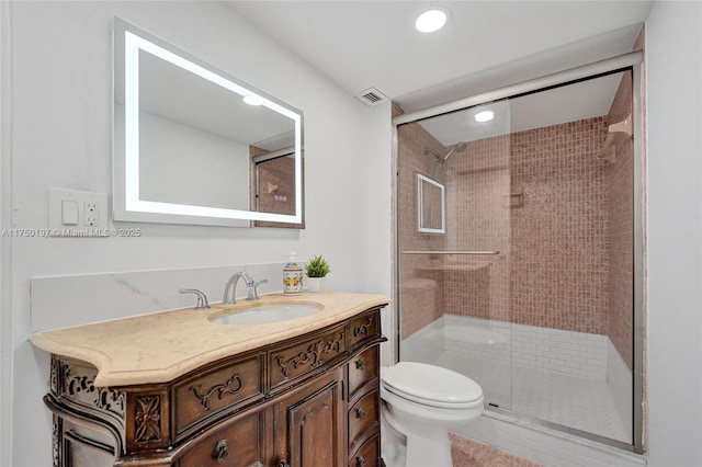 full bath featuring visible vents, a stall shower, vanity, and toilet