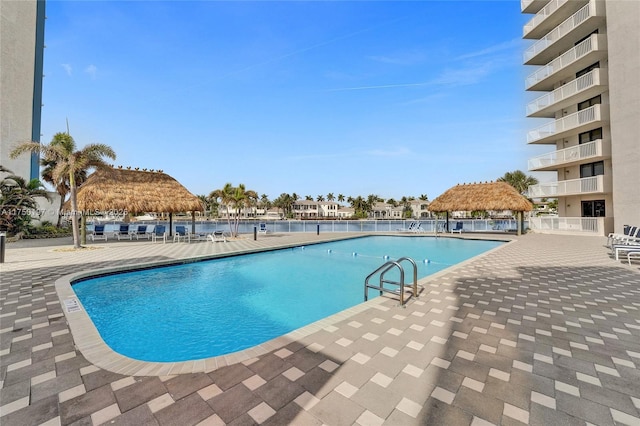 community pool featuring fence and a gazebo