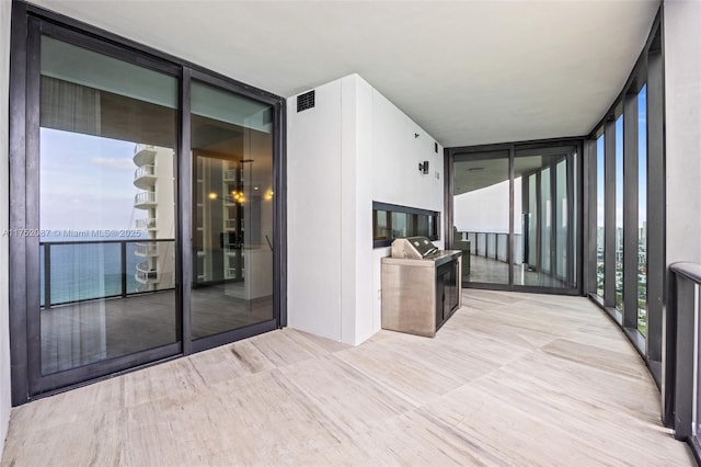 unfurnished sunroom with visible vents