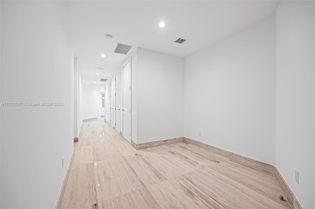 unfurnished room with baseboards, visible vents, and recessed lighting