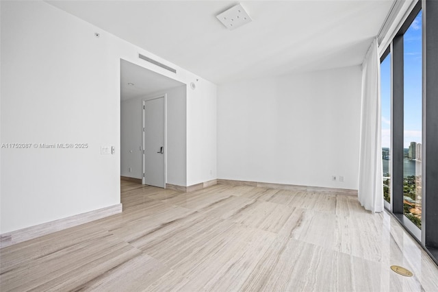 spare room with baseboards