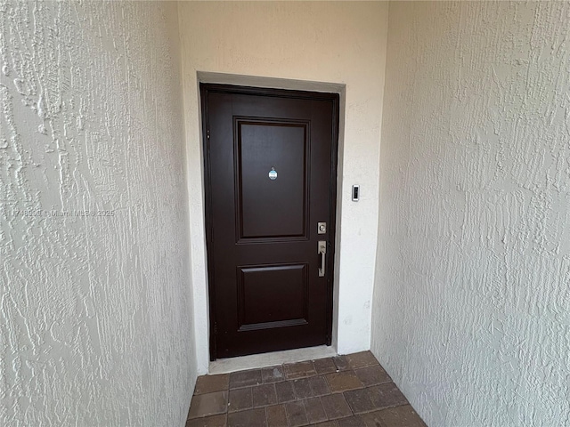 doorway to property with stucco siding