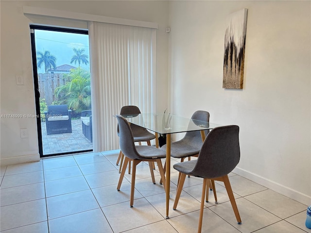 dining area featuring light tile patterned floors and baseboards