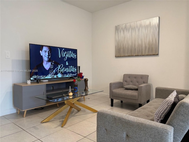 living area with baseboards and tile patterned floors