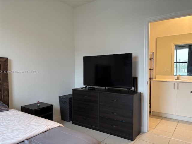 bedroom featuring light tile patterned flooring and a sink