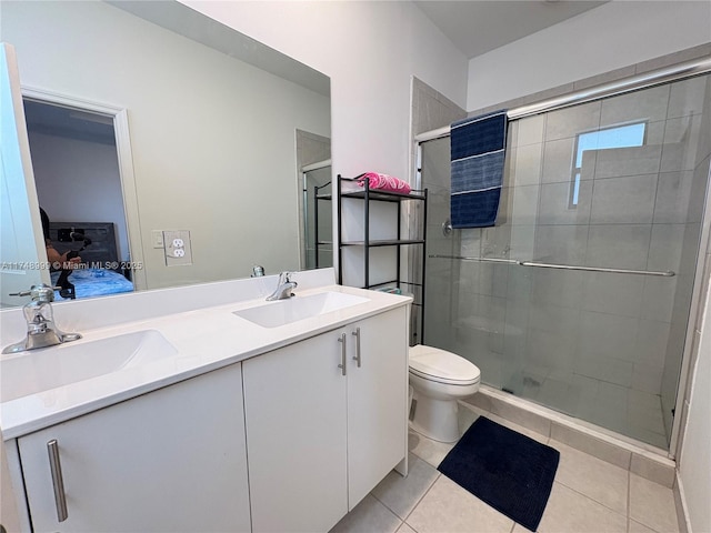 full bath with double vanity, toilet, a sink, and ensuite bathroom