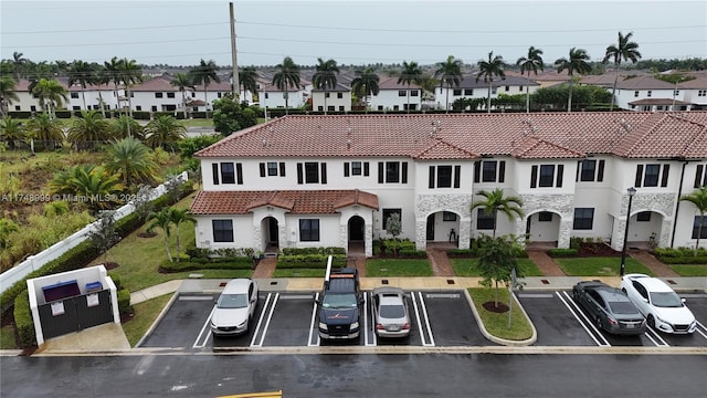 view of property with uncovered parking and a residential view