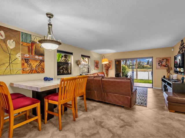 dining space with a textured ceiling