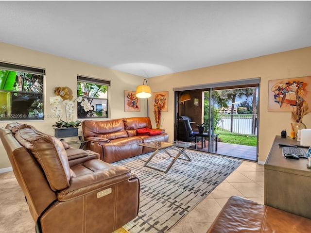 living area with baseboards and light tile patterned floors