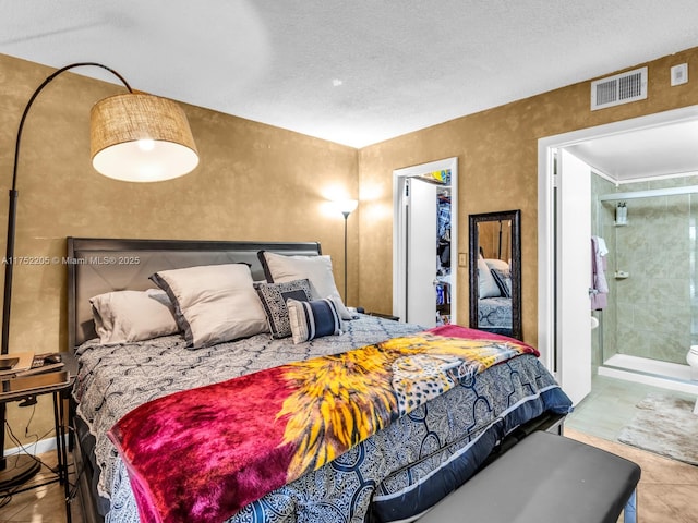 bedroom featuring ensuite bath and visible vents