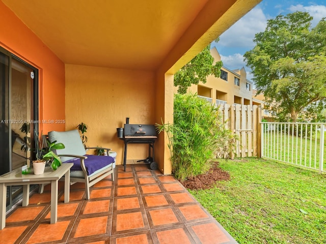 view of patio featuring a balcony and a grill