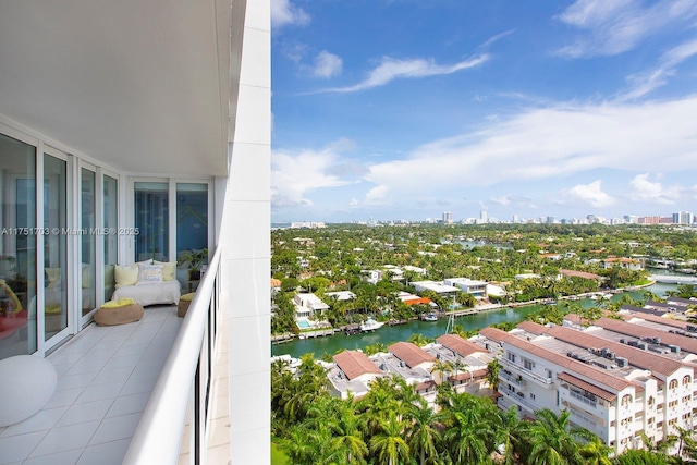 balcony with a water view and a view of city