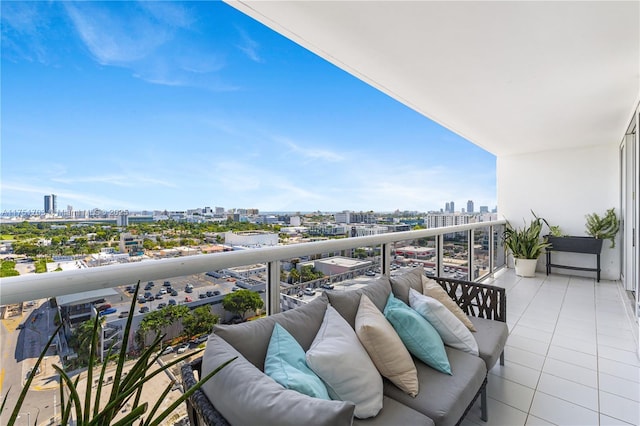 balcony with outdoor lounge area and a city view