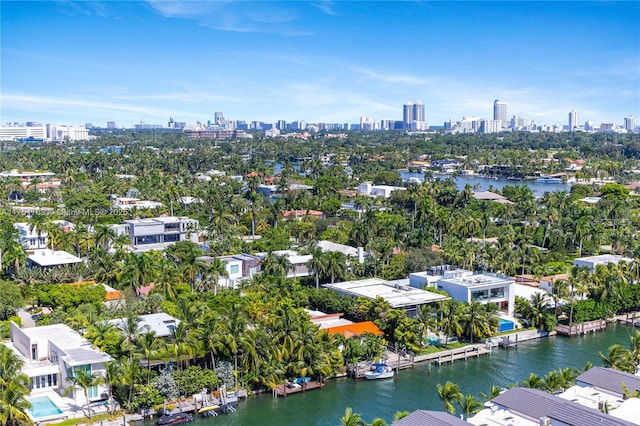 birds eye view of property with a view of city and a water view