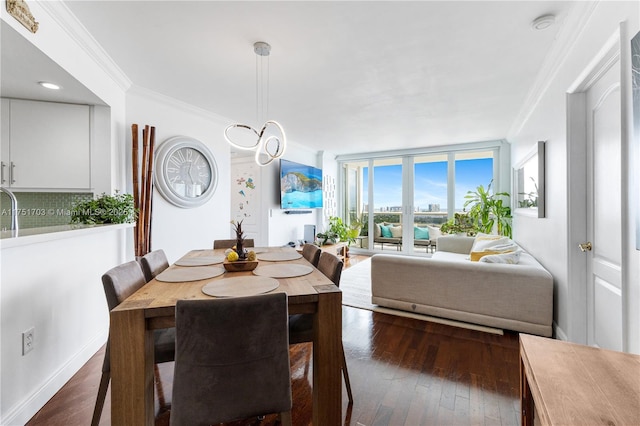 dining area featuring dark wood-style flooring, floor to ceiling windows, and crown molding