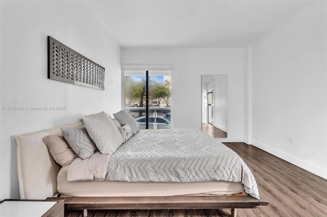 bedroom featuring baseboards and wood finished floors