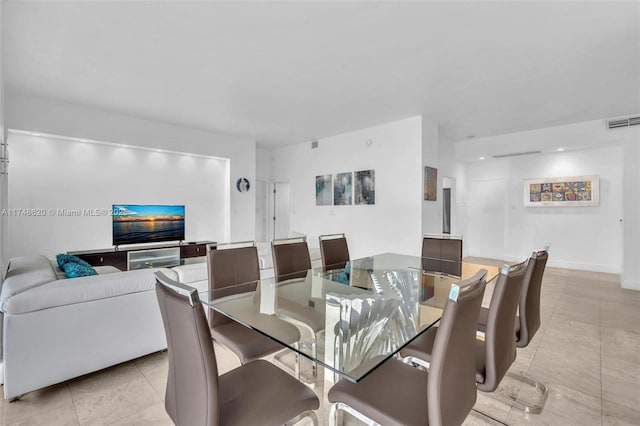 dining area featuring baseboards, visible vents, and tile patterned floors