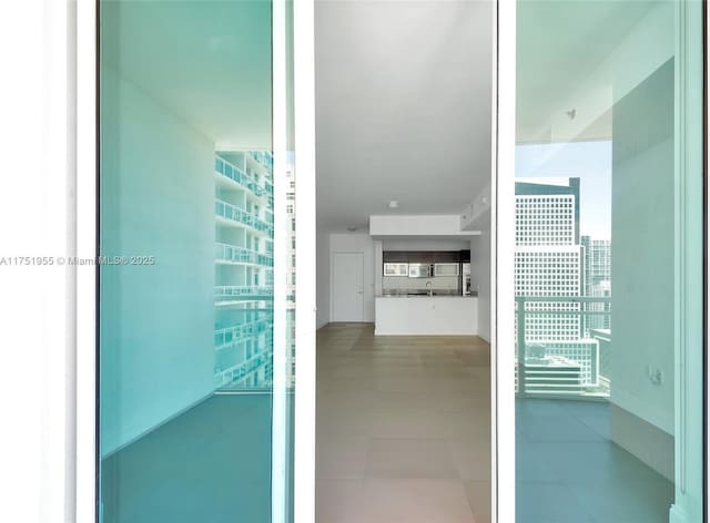 interior space featuring tile patterned flooring and a city view