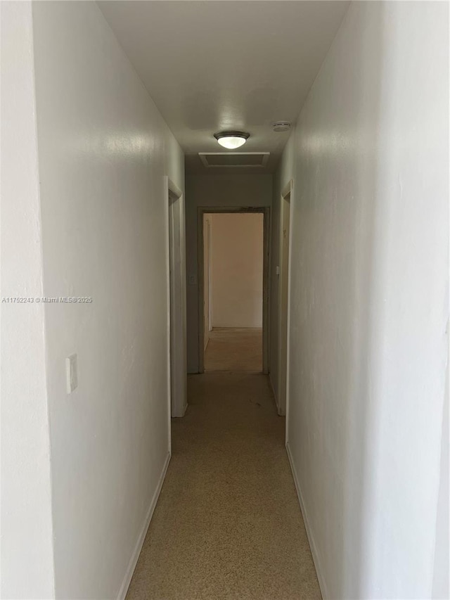 hall featuring baseboards