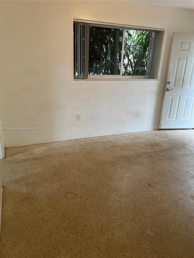 unfurnished room featuring carpet flooring