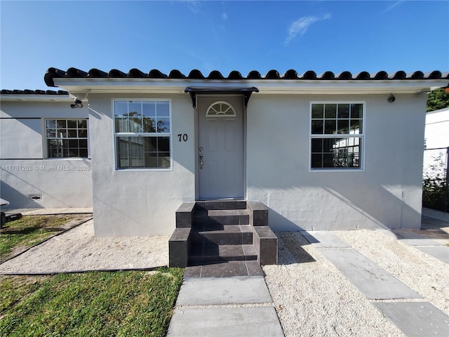 view of front of house featuring entry steps and stucco siding