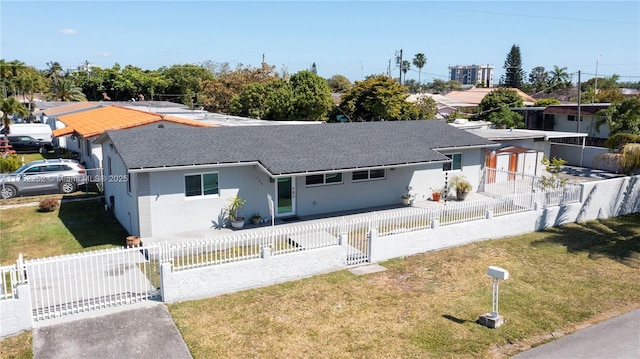 single story home featuring a fenced front yard, stucco siding, and roof with shingles