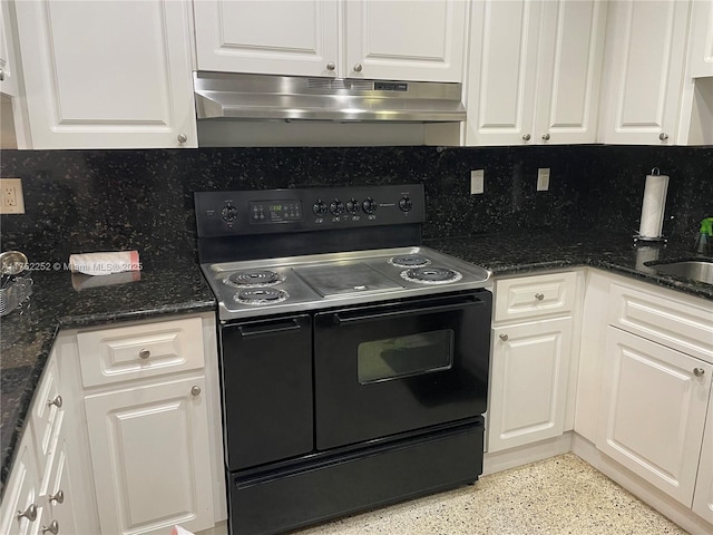 kitchen with white cabinets, under cabinet range hood, and range with two ovens