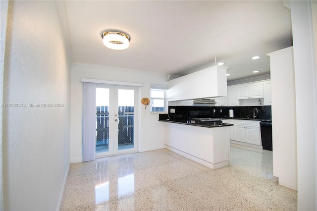 kitchen featuring a sink, black appliances, french doors, light speckled floor, and tasteful backsplash