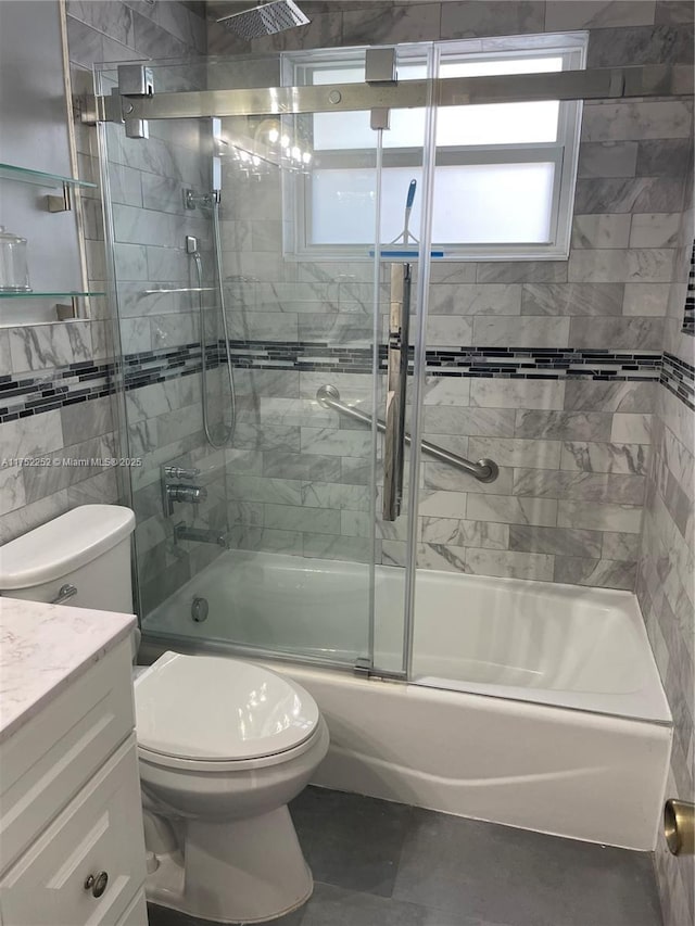 bathroom with toilet, combined bath / shower with glass door, and vanity