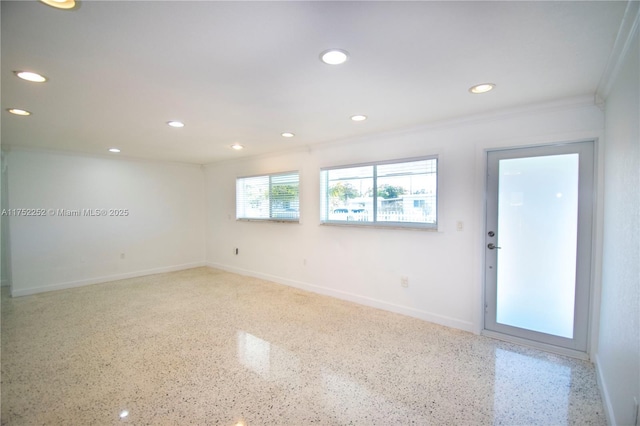 unfurnished room featuring recessed lighting, speckled floor, and baseboards