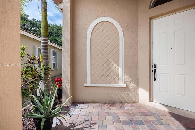 entrance to property with stucco siding