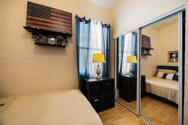 bedroom featuring light wood-style floors and a closet