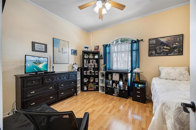 bedroom featuring crown molding, light wood finished floors, and ceiling fan